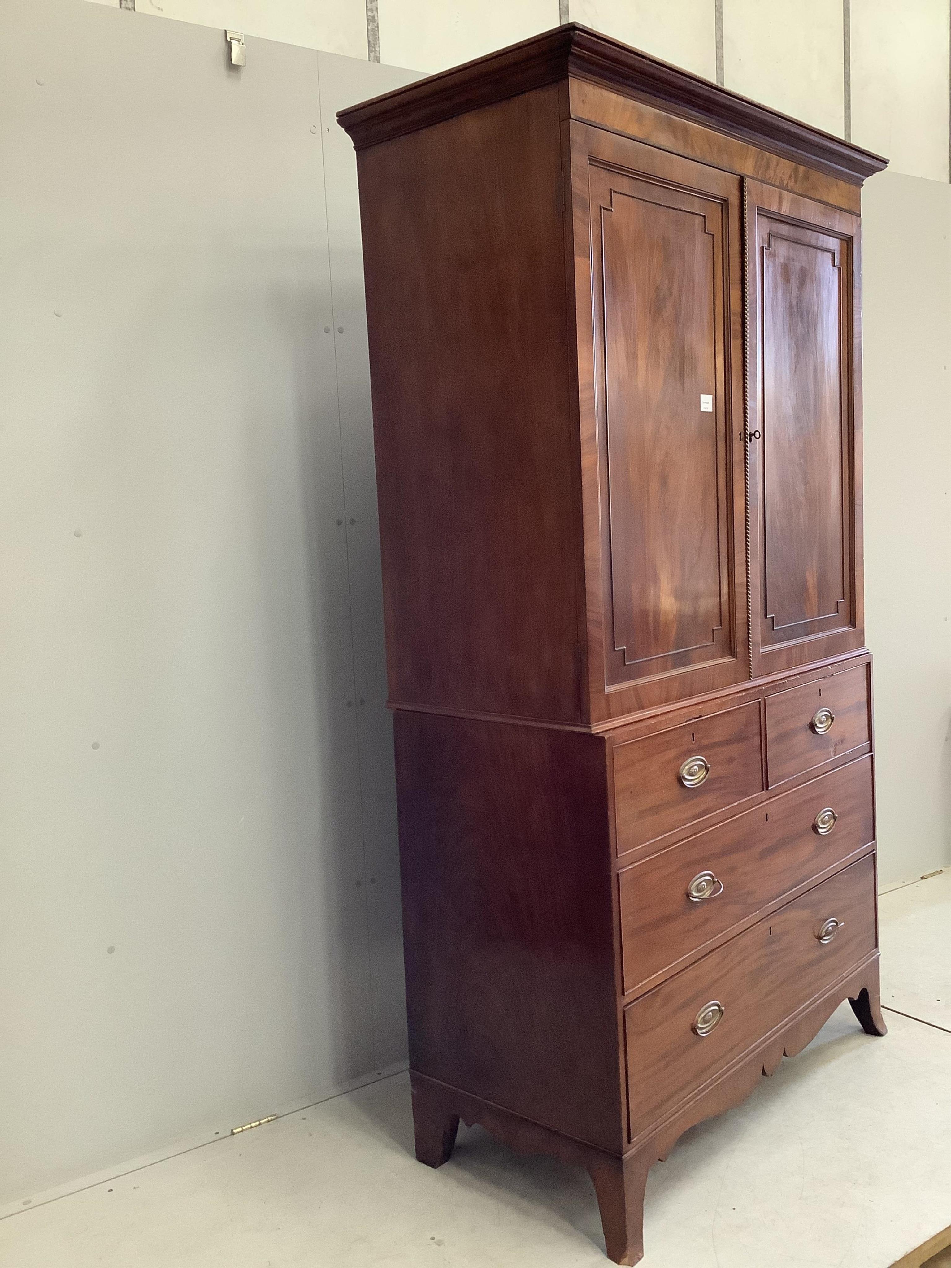 A Regency mahogany linen press, width 120cm, depth 56cm, height 211cm. Condition - fair, interior shelves are later